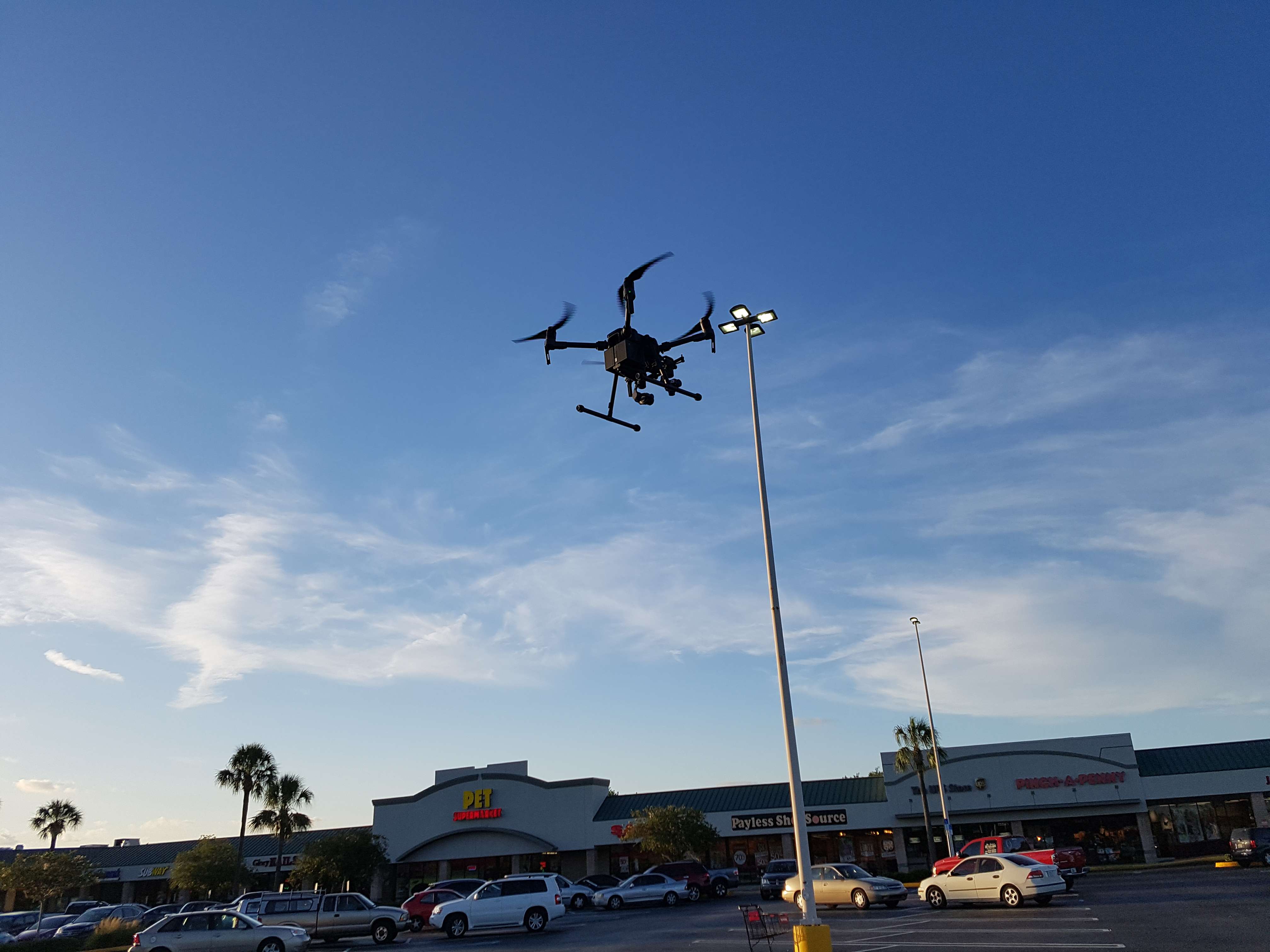 DJI inspection drone in flight over commercial strip mall