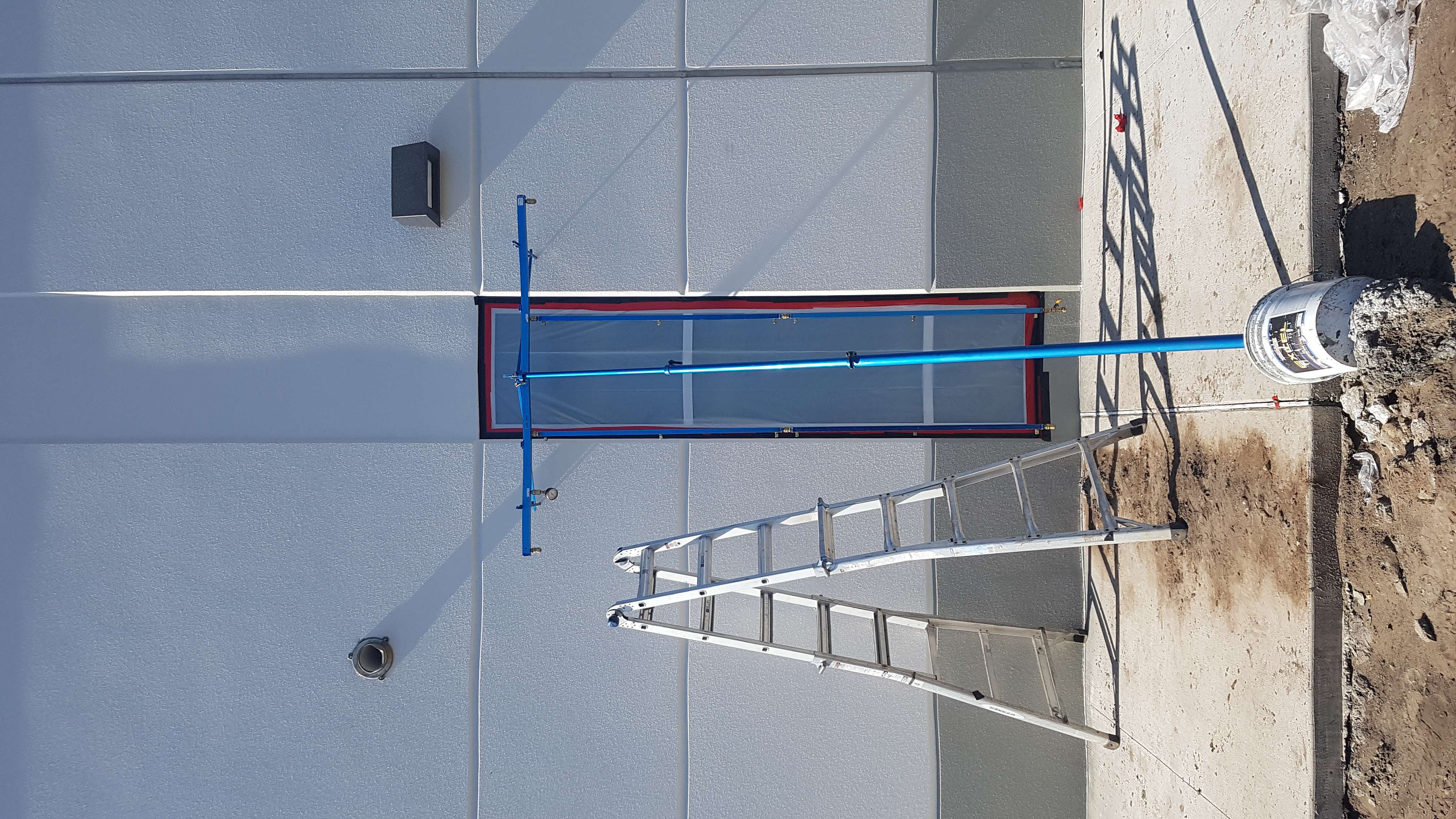 AAMA spray rack mounted on building exterior for water penetration testing